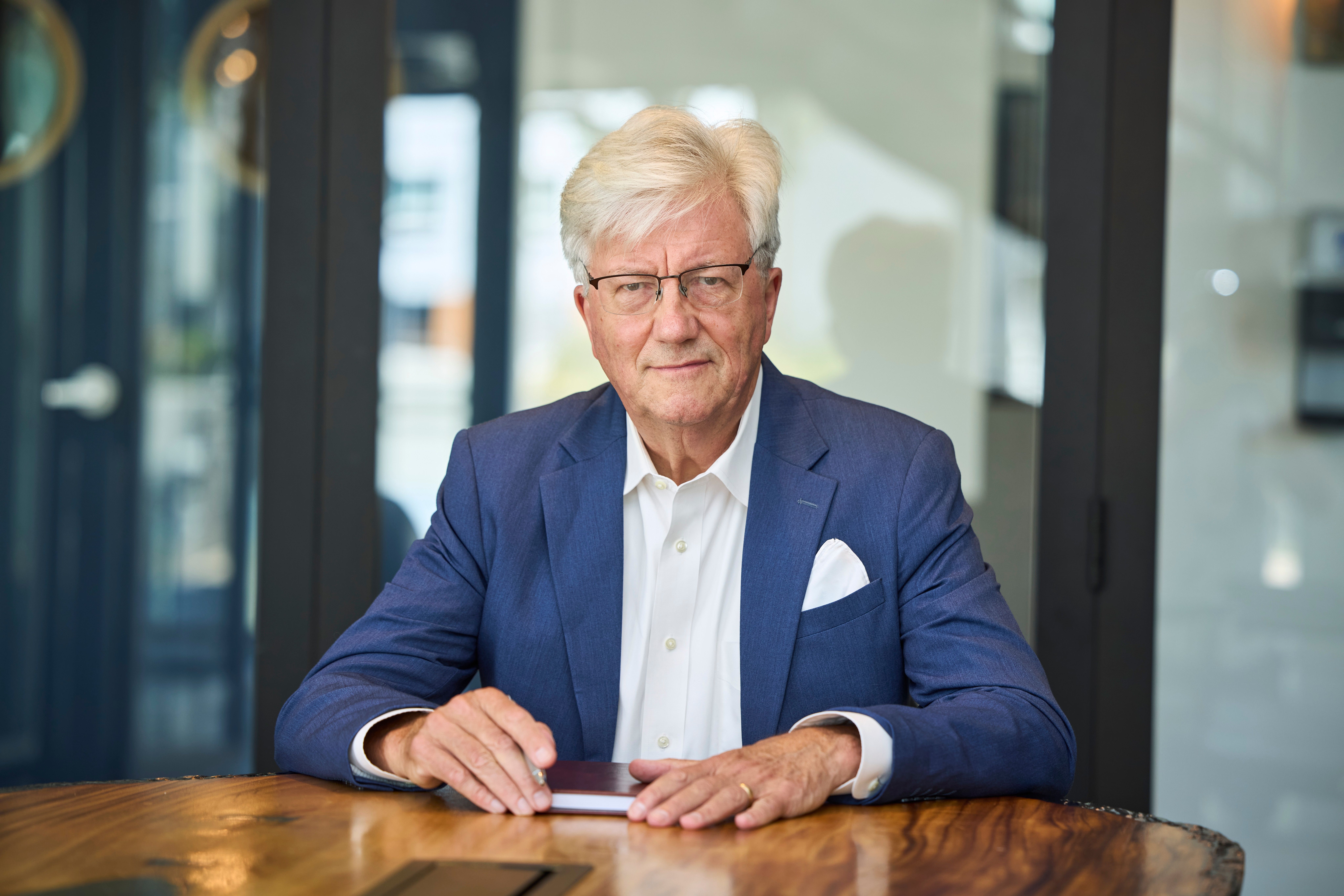 Stephen Dill at the boardroom table, cabinet-level executive presence